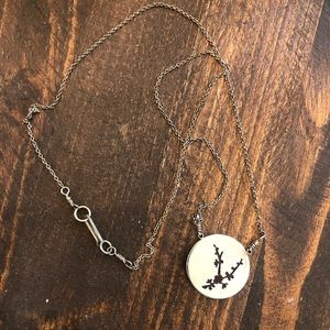 Silver necklace with red glass flower detail